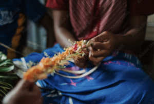 ALT TEXT: Fijian garland weaving