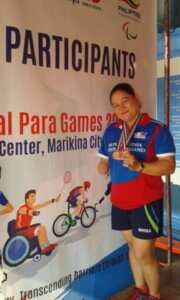 Minnie showing off her medals at the National Para Games in the Philippines. 